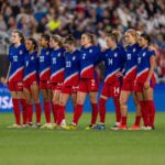 The USWNT stands on the field during penalty kicks