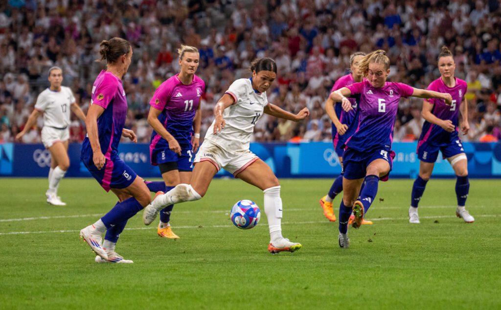 Sophia Smith takes a shot surrounded by German defenders in the USWNT's 4-1 Olympic group stage defeat of Germany.