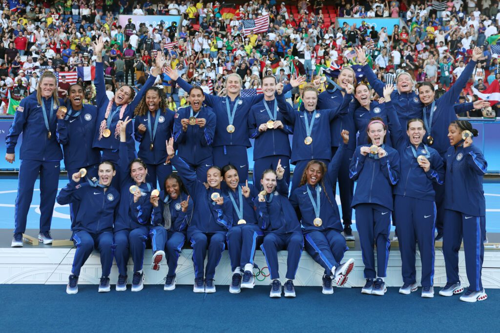 USWNT poses with their Olympic gold medals after Saturday's victory over Brazil