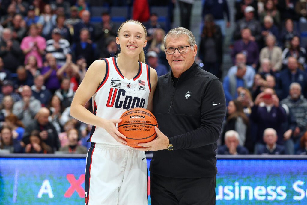 NCAA basketball UConn Huskies guard Paige Bueckers (5) pose for pictures with UConn Huskies head coach Geno Auriemma honoring 1,000 career point prior to the women's college basketball game between Louisville Cardinals and UConn Huskies.
