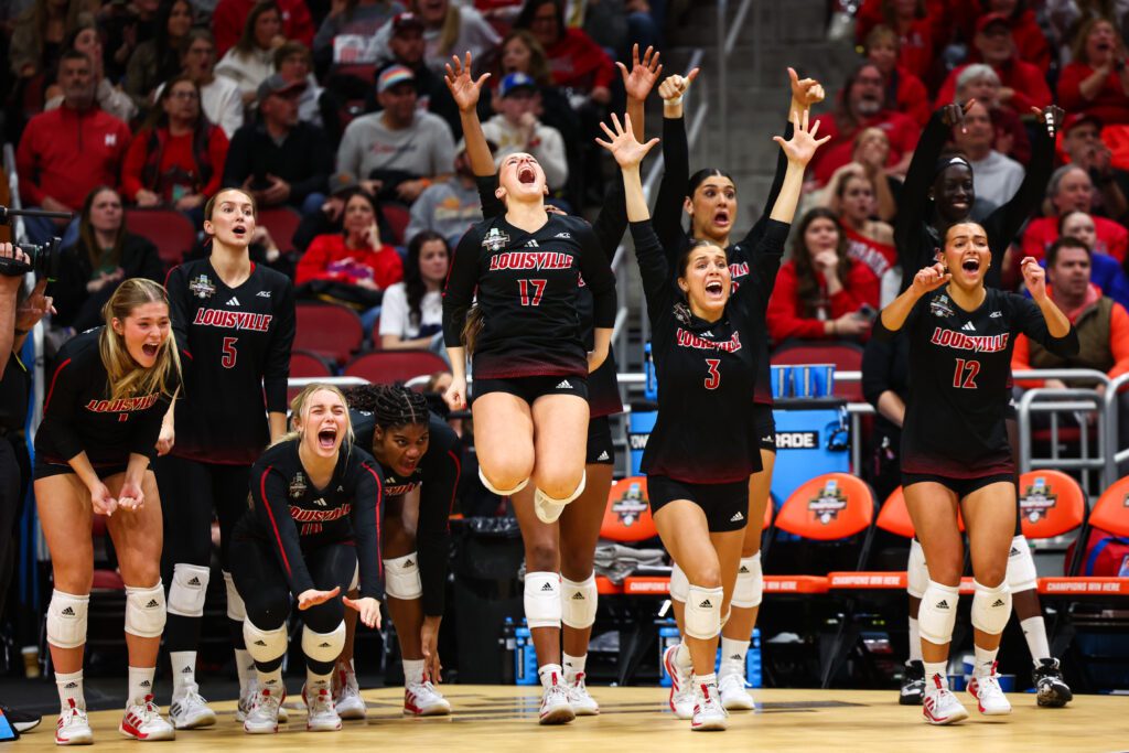 Louisville volleyball players celebrate a play against Pitt in Thursday's NCAA semifinal.