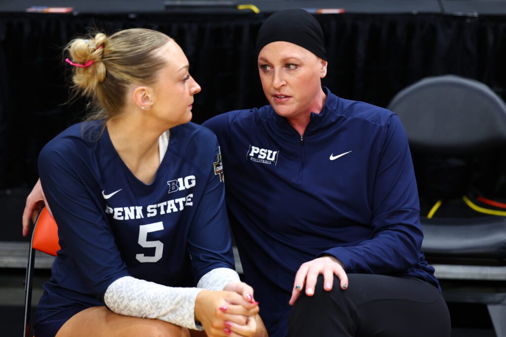 Penn State volleyball head coach Katie Schumacher-Cawley gives player Jordan Hopp directions on the 2024 NCAA semifinals sideline.