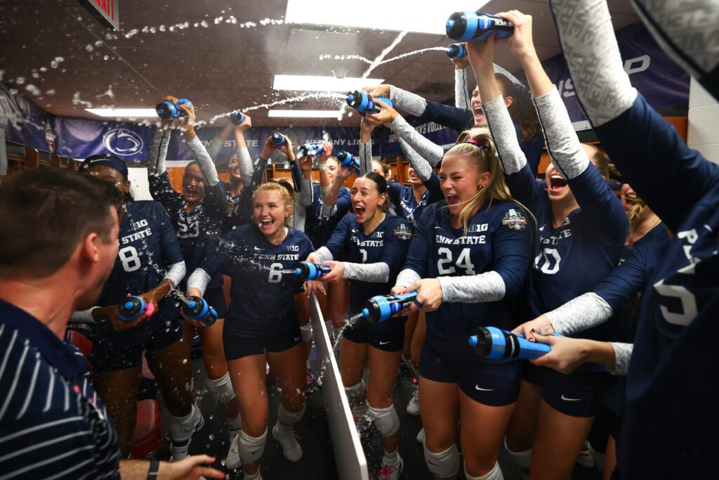 Penn State volleyball celebrate their NCAA semifinal upset win over Nebraska in their locker room.