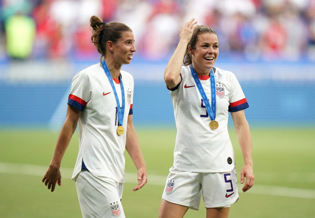 USWNT stars Tobin Heath and Kelley O'Hara wear their 2019 World Cup championship medals.