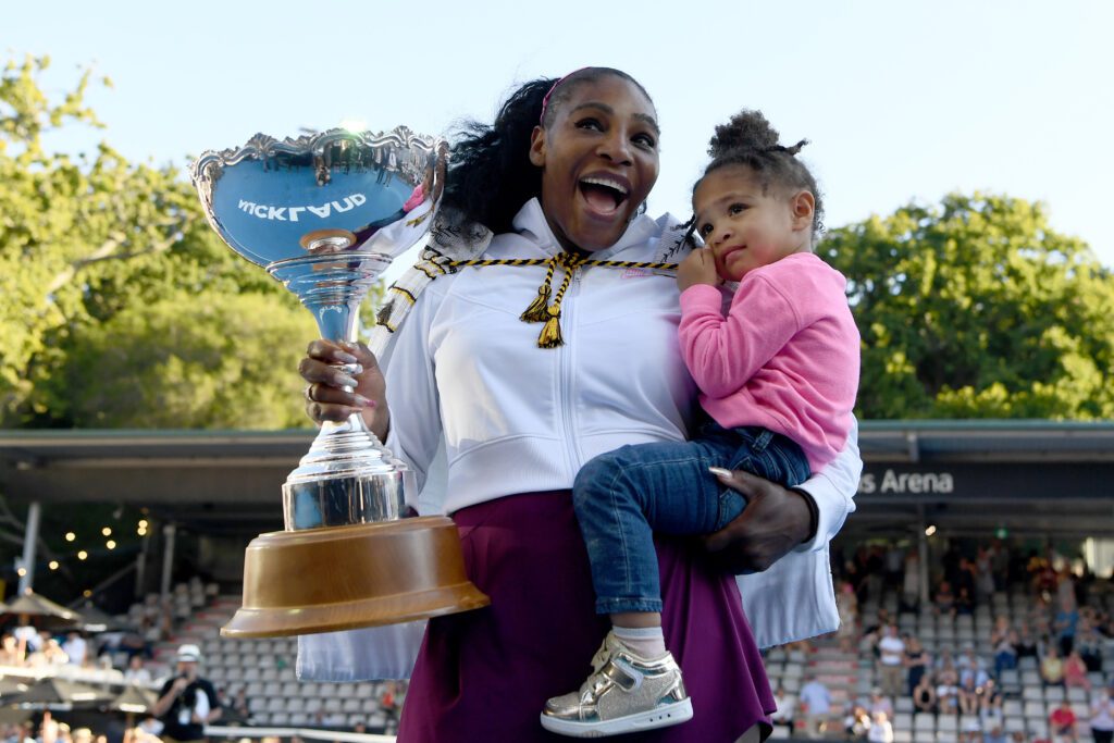 US tennis star Serena Willams holds the 2020 ASB Classic trophy in one hand and her daughter Olympia in the other.