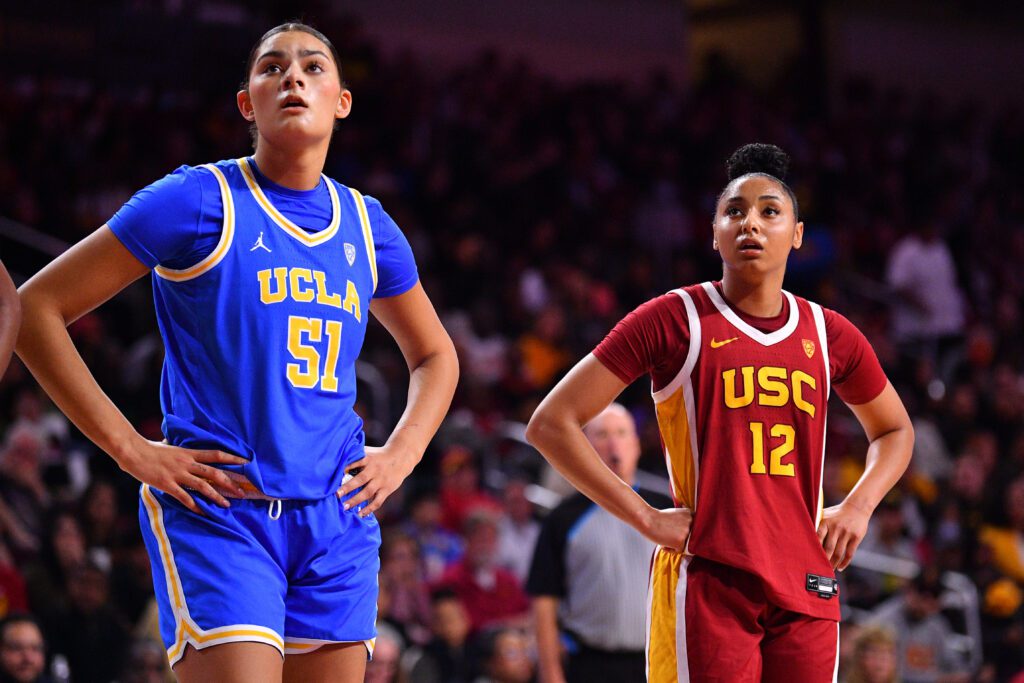 UCLA's Lauren Betts, sister of McDonald's All-American Game MVP Sienna Betts, and USC's JuJu Watkins look up during an NCAA basketball game.