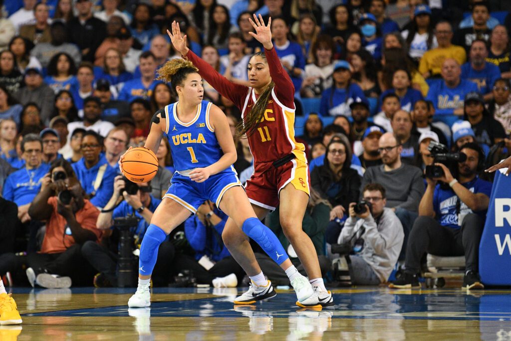 USC's Kennedy Smith guards UCLA's Kiki Rice during the LA rivals' 2024/25 Big Ten basketball regular-season finale.