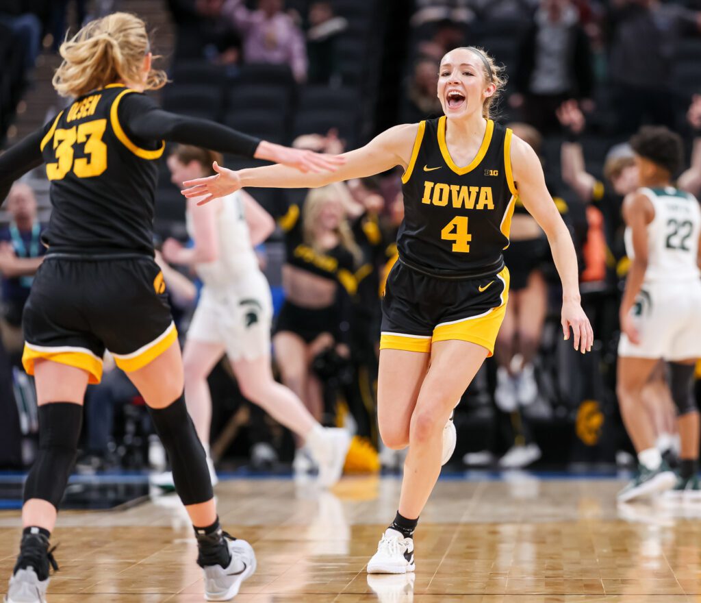 Iowa's Kylie Feuerbach celebrates their second-round 2025 Big Ten conference tournament victory with teammate Lucy Olsen.