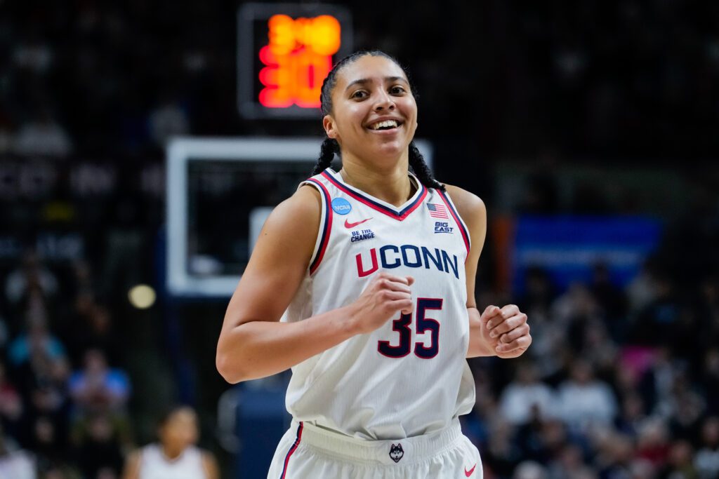 Instagram podcast star Azzi Fudd smiles during UConn first-round 2024/25 NCAA tournament game against Arkansas State.