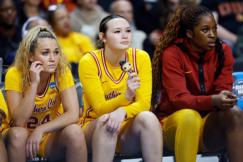 Kayleigh Heckel #9 of the USC Trojans holds a bobblehead of JuJu Watkins #12 in the second quarter against the Kansas State Wildcats in the Sweet Sixteen round of the NCAA Women's March Madness at Spokane Arena on March 29, 2025 in Spokane, Washington.