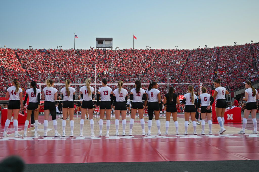 Nebraska volleyball lines up on the court for the August 2023 Volleyball Day in the university's football stadium.