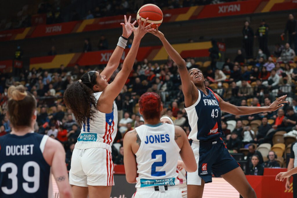France teen star Dominique Malonga wins the ball during a 2024 Olympic qualifying game against Puerto Rico.