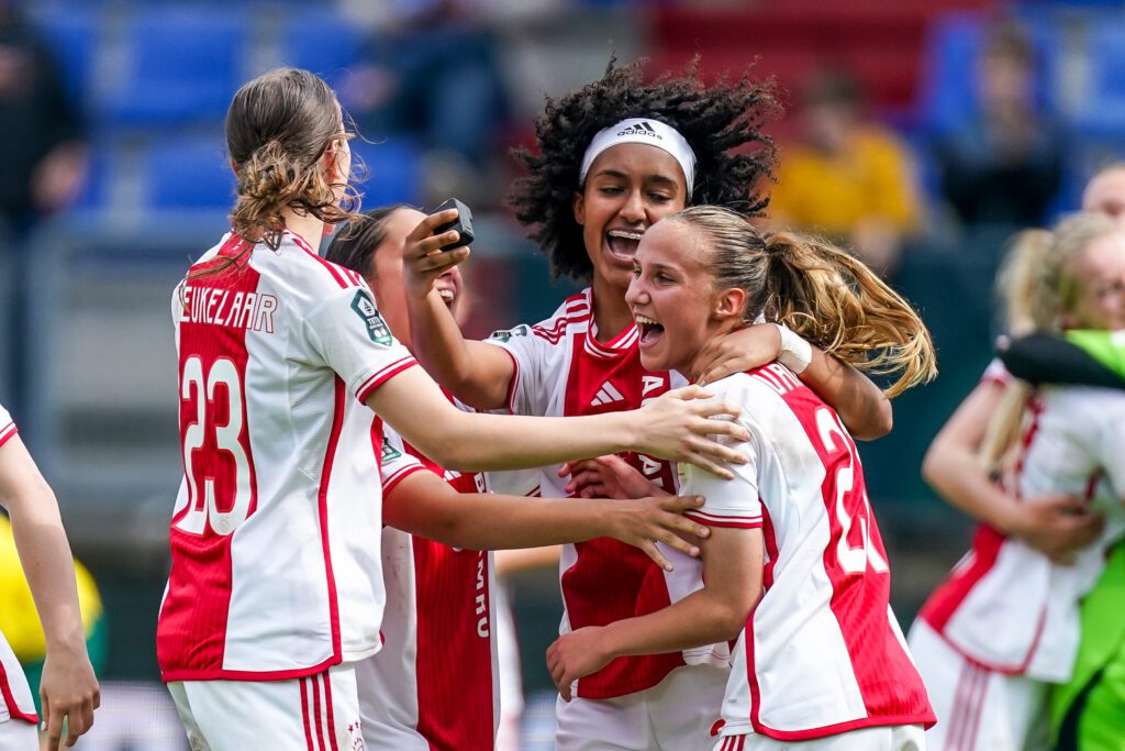 Ajax's Lotte Keukelaar, Lily Yohannes, and Rosa van Gool celebrate winning the 2024 KNVB Cup.