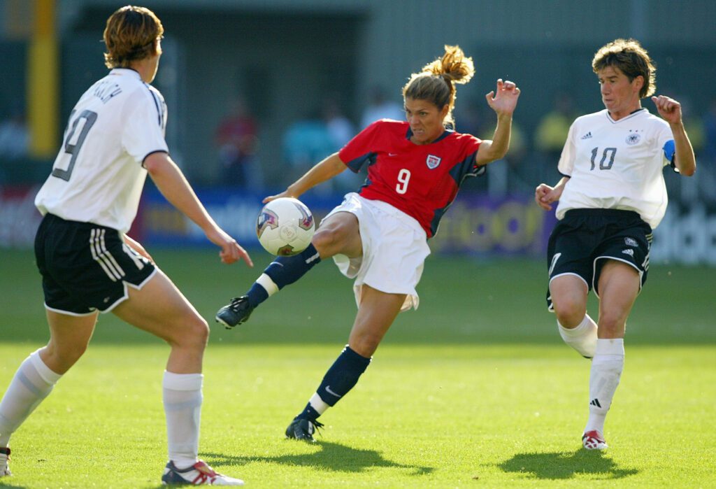 Mia Hamm #9 of the US kicks against the defense of Germany during the semifinals of the FIFA Women's World Cup match on October 5, 2003.