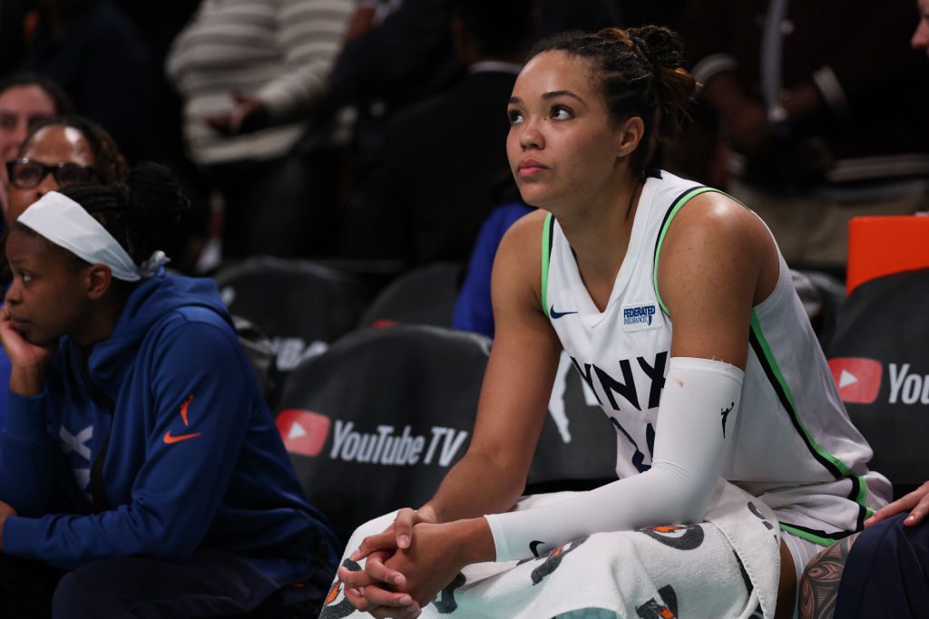 WNBA star and Jordan Brand athlete Napheesa Collier sits on the bench during a 2024 Minnesota Lynx game.