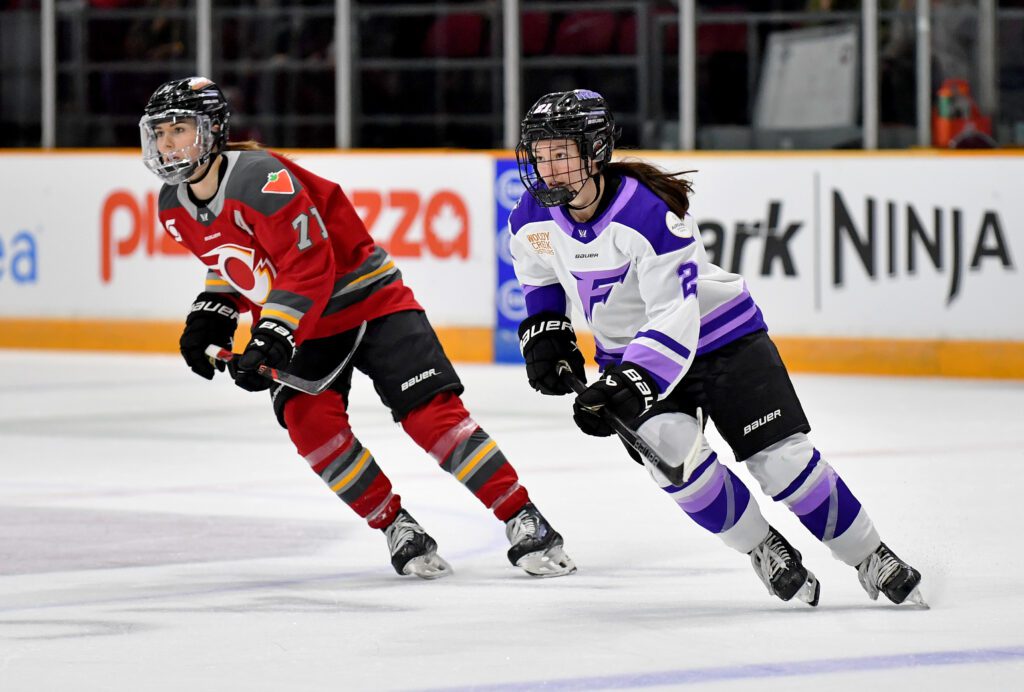 Ottawa's Jincy Roese and Minnesota's Liz Schepers skate during a 2025 PWHL game.