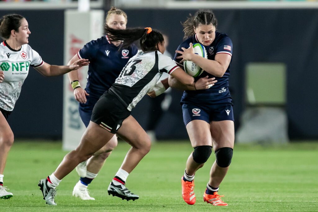 USA rugby star Ilona Maher carries the ball during a game against Canada.