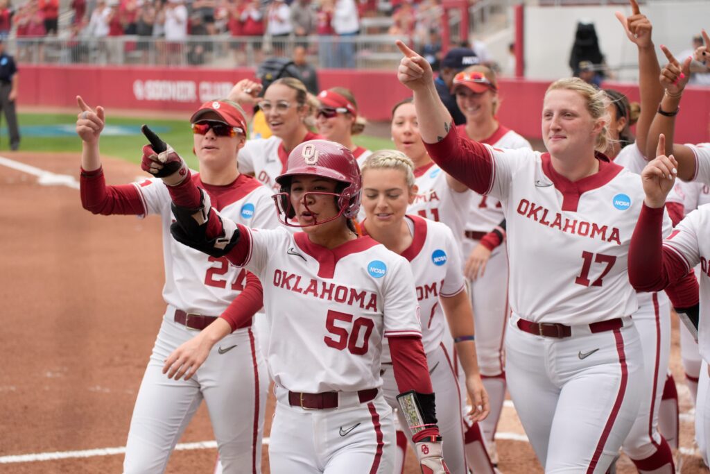 Oklahoma's Ailana Agbayani celebrates her three-run homer with her team during the 2025 NCAA softball tournament.