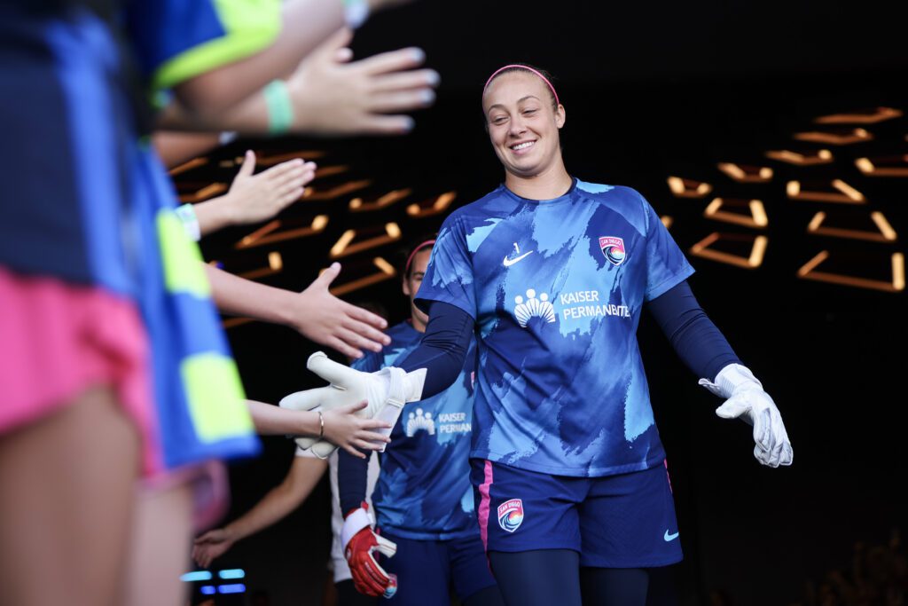 Kailen Sheridan #1 of San Diego Wave FC greets young fans on the way out to warm ups before the game against North Carolina Courage at Snapdragon Stadium on September 08, 2024 in San Diego, California.