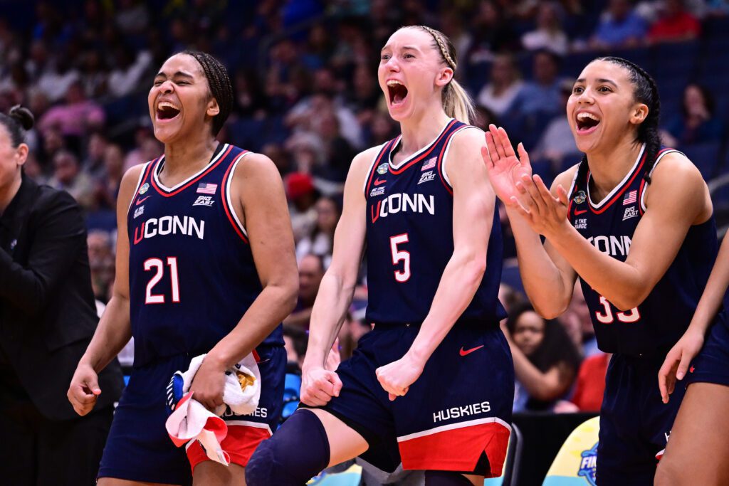 Paige Bueckers #5, and Instagram podcast star Azzi Fudd #35 of the UConn Huskies react on the bench against the UCLA Bruins during the NCAA Women's Basketball Tournament Final Four.