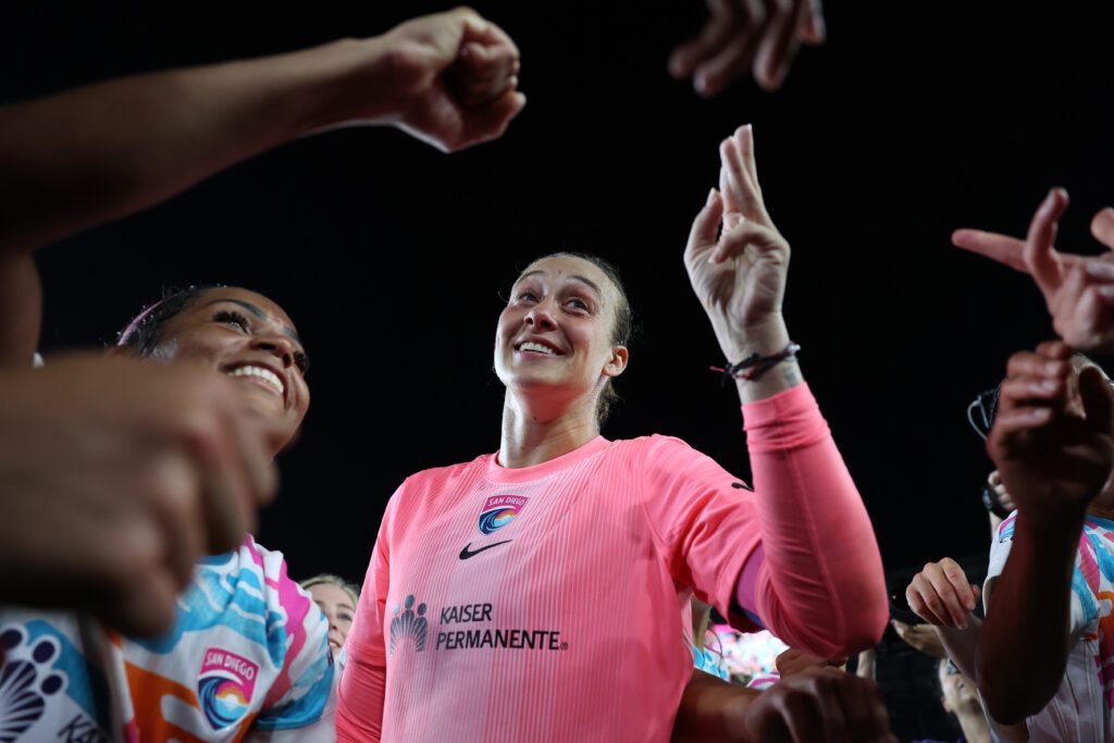 Kailen Sheridan #1 of San Diego Wave FC celebrates in a huddle with teammates following the team's victory in the NWSL match between NJ/NY Gotham FC and San Diego Wave.