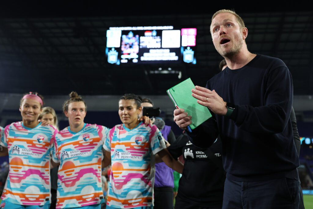 Jonas Eidevall, Head Coach of San Diego Wave FC, talks to the team in a huddle following the team's victory in the NWSL match between NJ/NY Gotham FC and San Diego Wave.