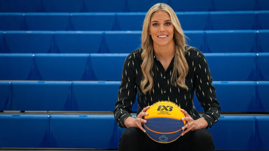 Retired WNBA star Elena Delle Donne poses holding an official 3x3 basketball.