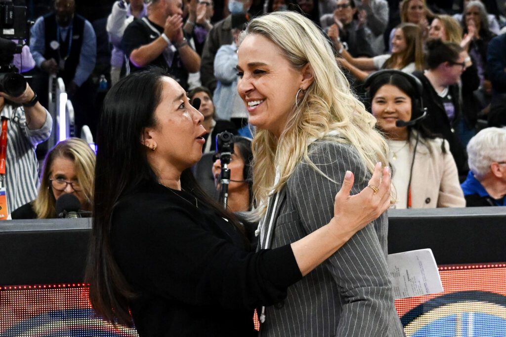 Head coach Natalie Nakase of the Golden State Valkyries greets head coach Becky Hammon of the Las Vegas Aces after defeating the Las Vegas Aces at Chase Center.
