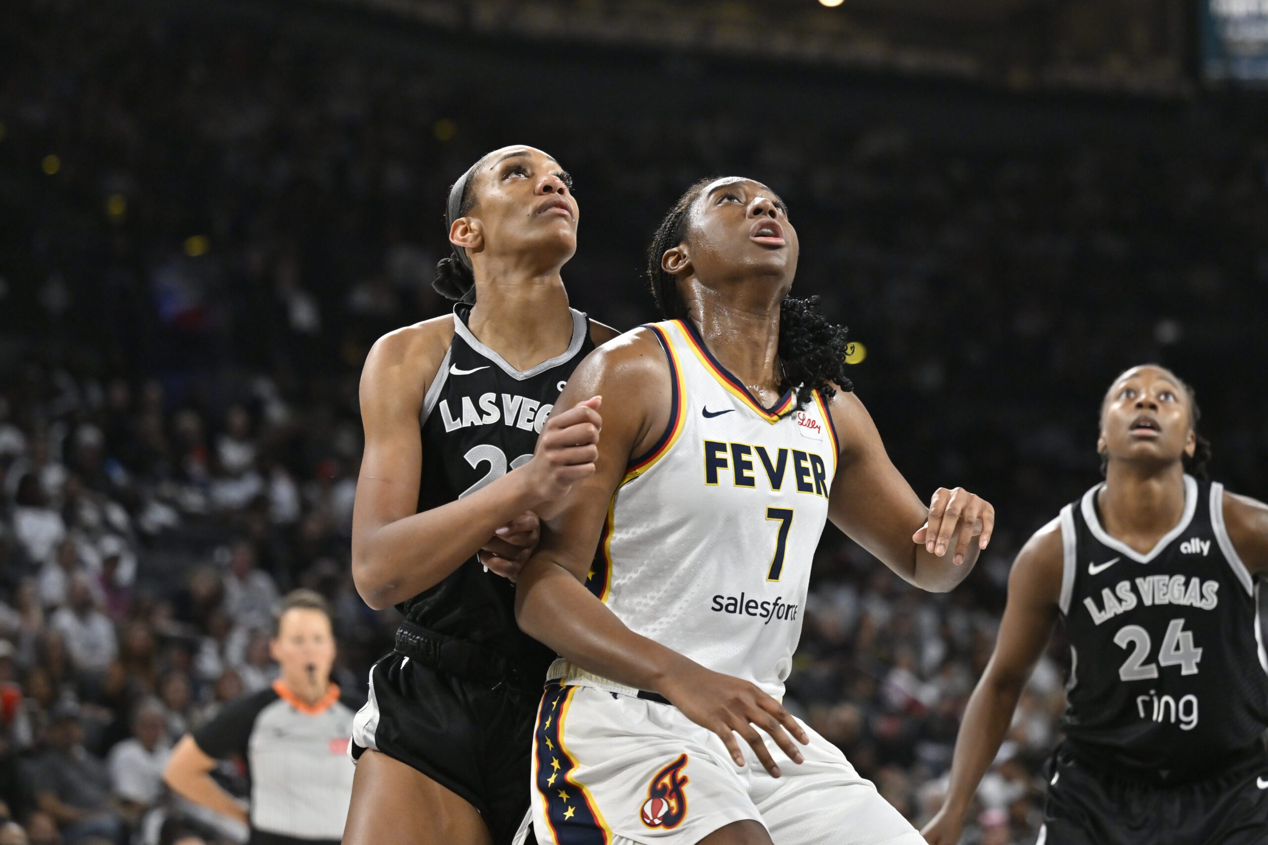Indiana Fever center Aliyah Boston and Las Vegas Aces forward A'ja Wilson look up for a rebound during Game 1 of the 2025 WNBA semifinals