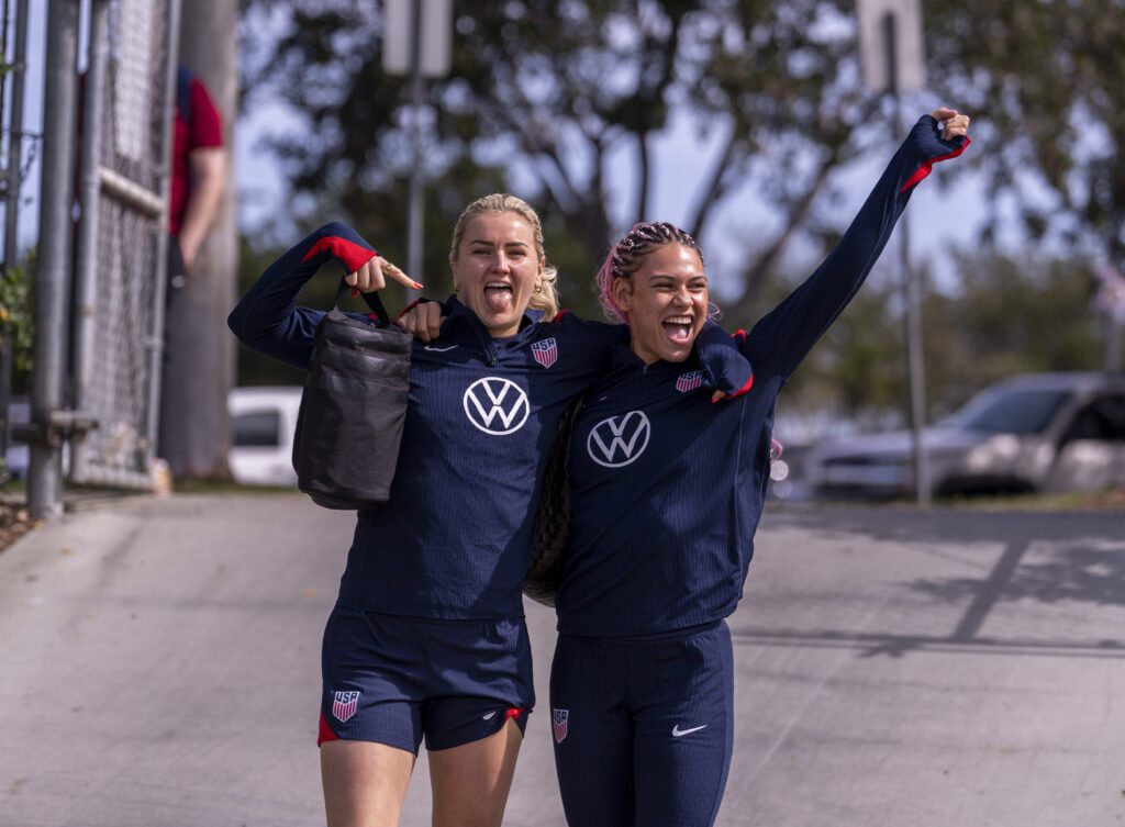 USWNT veteran stars Lindsey Heaps and Trinity Rodman are all smiles entering an April 2025 training session.