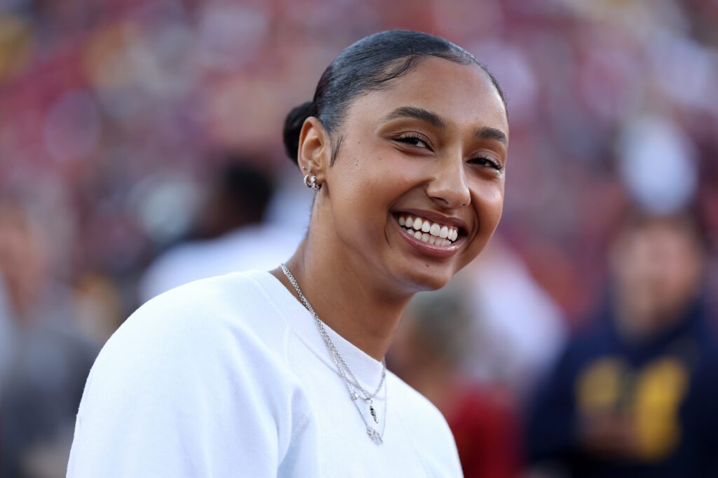 USC women's basketball star JuJu Watkins smiles while watching a 2025 USC football game.