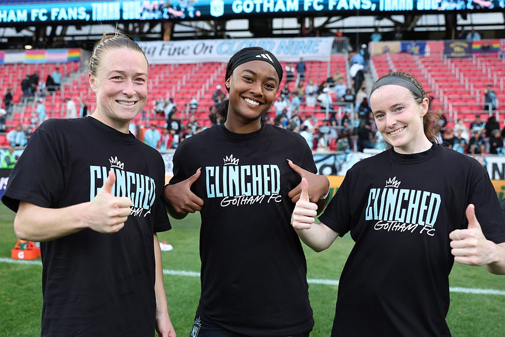 Emily Sonnet #6, Jaedyn Shaw #2 and Rose Lavelle #16 of NJ/NY Gotham FC celebrate the clinch to playoffs after the NWSL match between NJ/NY Gotham FC and Racing Louisville at Sports Illustrated Stadium on October 19, 2025 in Harrison, New Jersey.