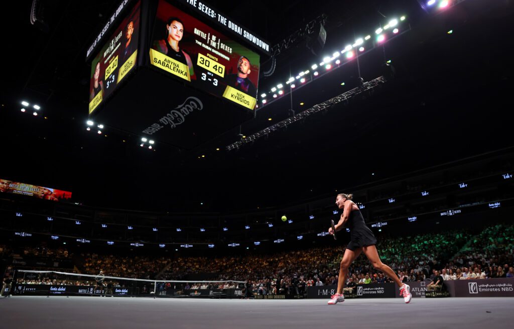 World No. 1 Aryna Sabalenka plays a backhand against ATP player Nick Kyrgios during a 2025 Battle of the Sexes exhibition match in Dubai.
