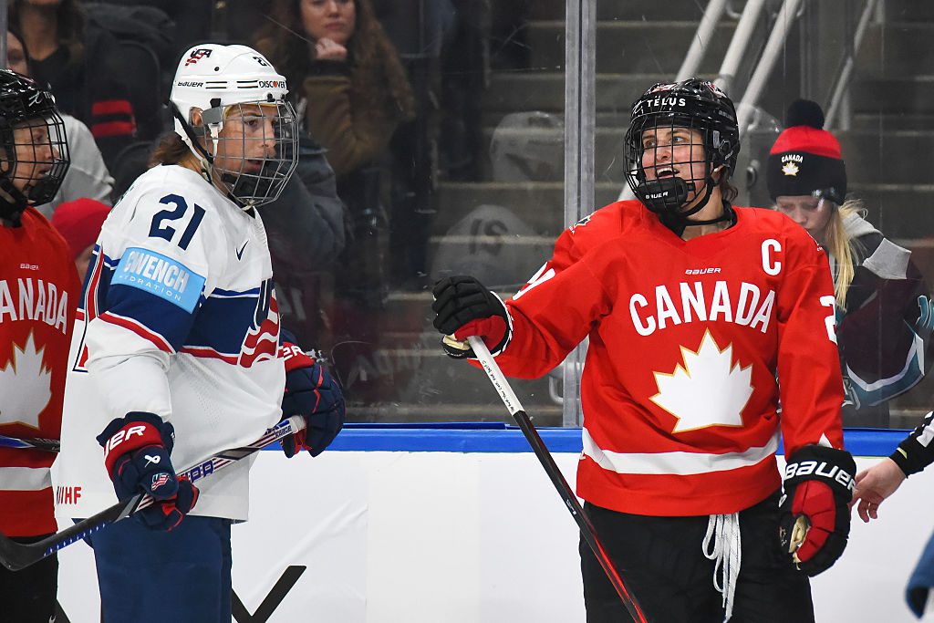 Marie-Philip Poulin #29 of Team Canada and Hilary Knight #21 of Team USA have a conversation during a stoppage in play during the third period of Game Two of the 2025 Rivalry Series Rogers Place on December 13, 2025, in Edmonton, Alberta, Canada.
