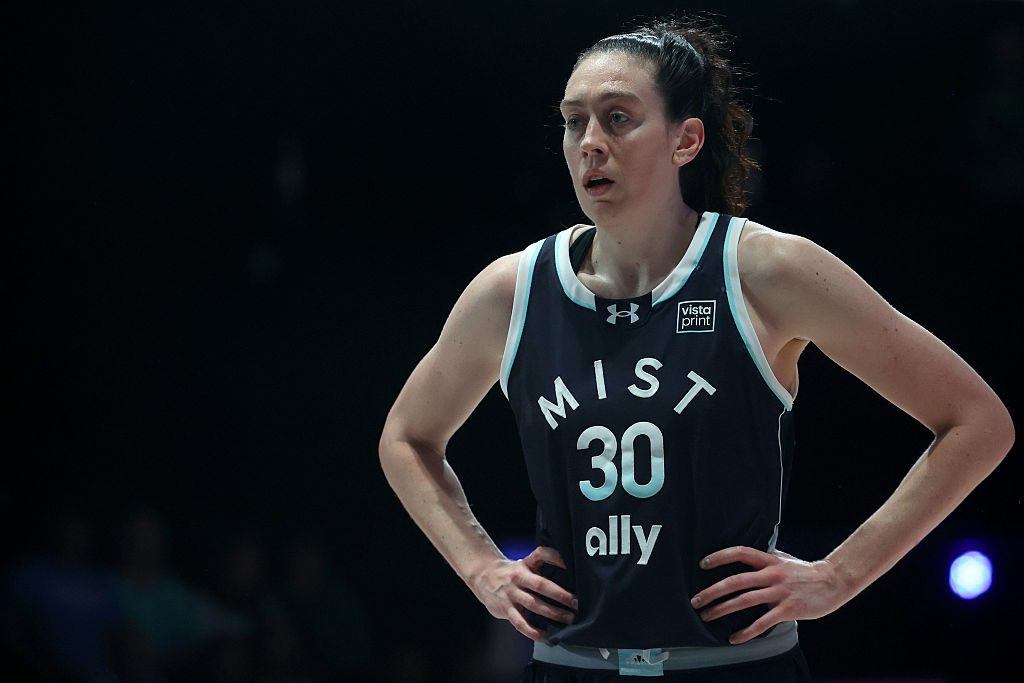 After holding a sign to protest the ICE shooting in Minneapolis, Breanna Stewart #30 of the Mist looks on against the Breeze during the second quarter of the Unrivaled 2026 game at Sephora Arena on January 19, 2026 in Medley, Florida.