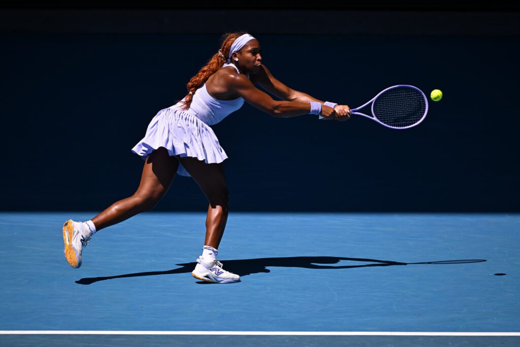 US tennis star Coco Gauff reaches for a backhand volley during her opening match at the 2026 Australian Open.