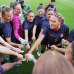 USWNT captain Trinity Rodman addresses her teammates in a huddle before a 2026 friendly against Paraguay.
