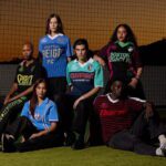 Models pose wearing knitwear jerseys from the new NWSL x Dead Dirt collection.
