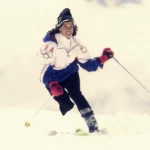 USA Paralympian Bonnie St. John smiles as she skis down the slope.