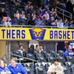 A banner saying "Panthers Basketball" hangs in the stands during a 2025/26 Pitt women's basketball game.