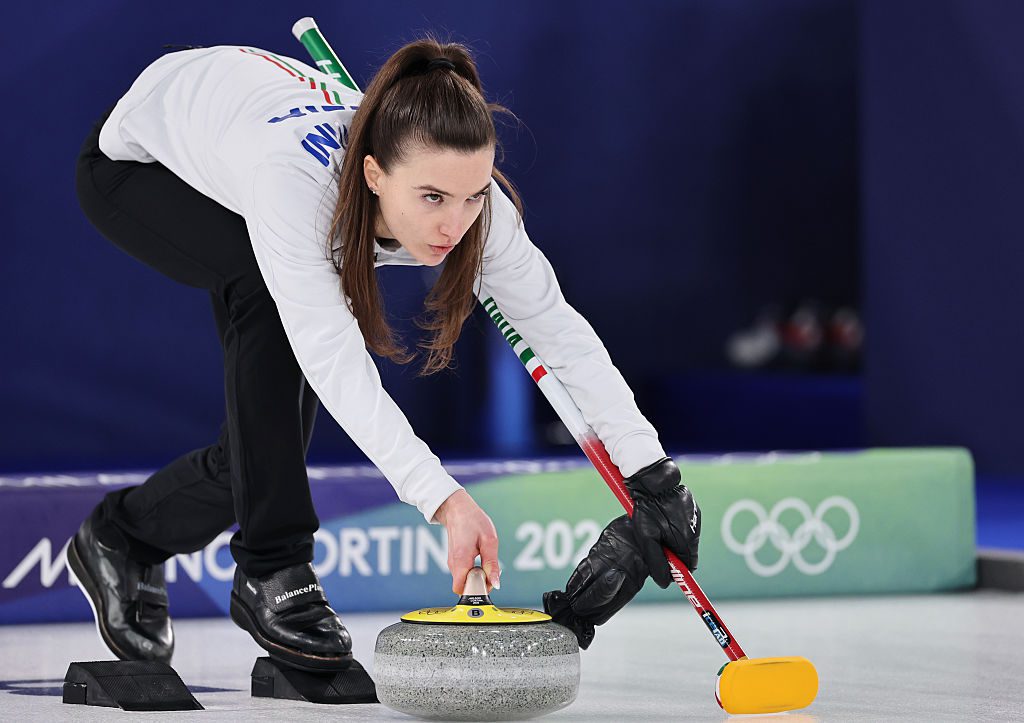 Stefania Constantini of Team Italy competes alongside Amos Mosaner in their match against Team United States during mixed doubles round robin on day three of the Milano Cortina 2026 Winter Olympic games at Cortina Curling Olympic Stadium on February 09, 2026 in Cortina d'Ampezzo, Italy.