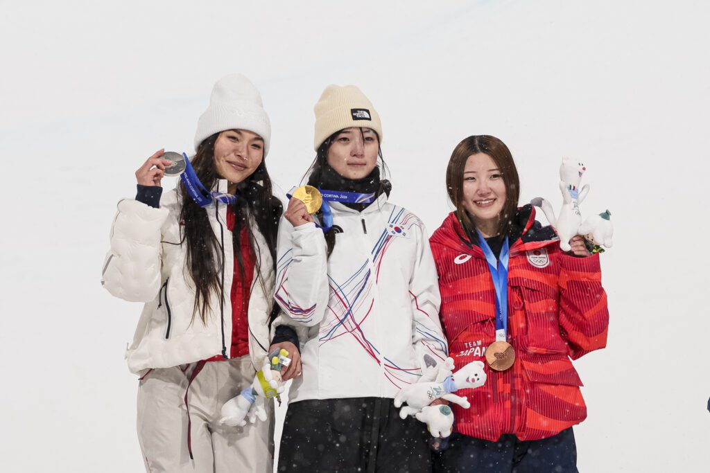 USA snowboard star Chloe Kim, South Korea's Gaon Choi, and Japan's Mitsuki Ono pose with their 2026 Olympic medals after the women's halfpipe event.